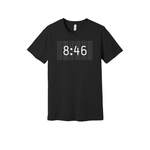 Crew-neck unisex black t-shirt
design features the striking numbers "8:46" in white, set against a backdrop of repeated text in gray that reads, "WE CANT BREATHE"
