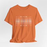 "Every Child Matters" statement in white text repeated on this burn orange crew neck t-shirt 5 times in a variation of getting lighter as it goes up and down from the bold white text in the center.  The shirt is displayed as a mockup with a wrinkled bottom as it is sitting on a table from a hanger. The color ORANGE signifies reclamation and remembrance of our Indigenous individuals and families, along with the over-arching inter-generational community impacts of Indian Residential Schools.