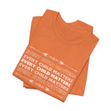 "Every Child Matters" statement in white text repeated on this burn orange crew neck t-shirt 5 times in a variation of getting lighter as it goes up and down from the bold white text in the center.  This shows two shirts folded in a mockup on top of one another at an angle. The color ORANGE signifies reclamation and remembrance of our Indigenous individuals and families, along with the over-arching inter-generational community impacts of Indian Residential Schools.