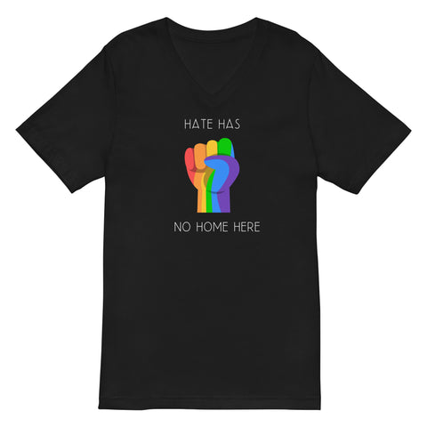 Black V-neck unisex t-shirt featuring a vibrant rainbow solidarity fist design in the center with white bold style text above "Hate Has" and the remaining text "No Home Here" directly below the fist. 
Emphasizing the power of inclusivity and love for all.