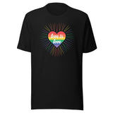 A black crew neck unisex t-shirt featuring a design of a vibrant rainbow-striped heart at the center with the text "love is love" written inside. Around the heart colorful, radiating lines, with sunburst effect emphasizing inclusivity and love for all.