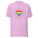 A lilac crew neck unisex t-shirt featuring a design of a vibrant rainbow-striped heart at the center with the text "love is love" written inside. Around the heart colorful, radiating lines, with sunburst effect emphasizing inclusivity and love for all.
