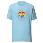 An ocean blue crew neck unisex t-shirt featuring a design of a vibrant rainbow-striped heart at the center with the text "love is love" written inside. Around the heart colorful, radiating lines, with sunburst effect emphasizing inclusivity and love for all.