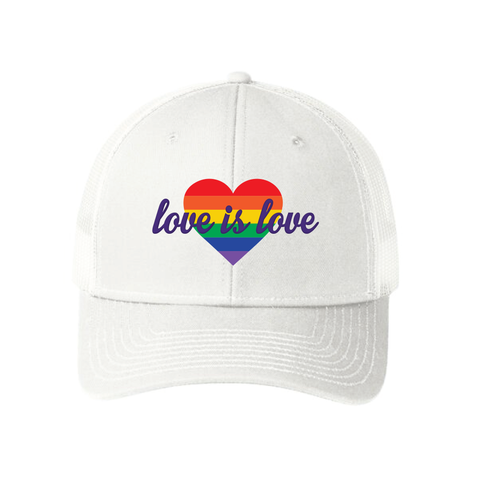 White unisex snapback trucker hat featuring a bold rainbow heart design on the front. The heart is filled with horizontal rainbow stripes, and the words "love is love" are written in elegant white script across it, symbolizing support for LGBTQIA2S+ equality and inclusivity.