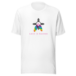 A white crew neck unisex t-shirt featuring a design centered around the Zia symbol, representing the sun with four rays. 

At the symbols center, begins two colorful PRIDE rainbow feathers, hanging over the symbol creating a love and spirituality vibrancy accent.

Below the design, "LOVE IS SACRED" text displayed in pink bold lettering.